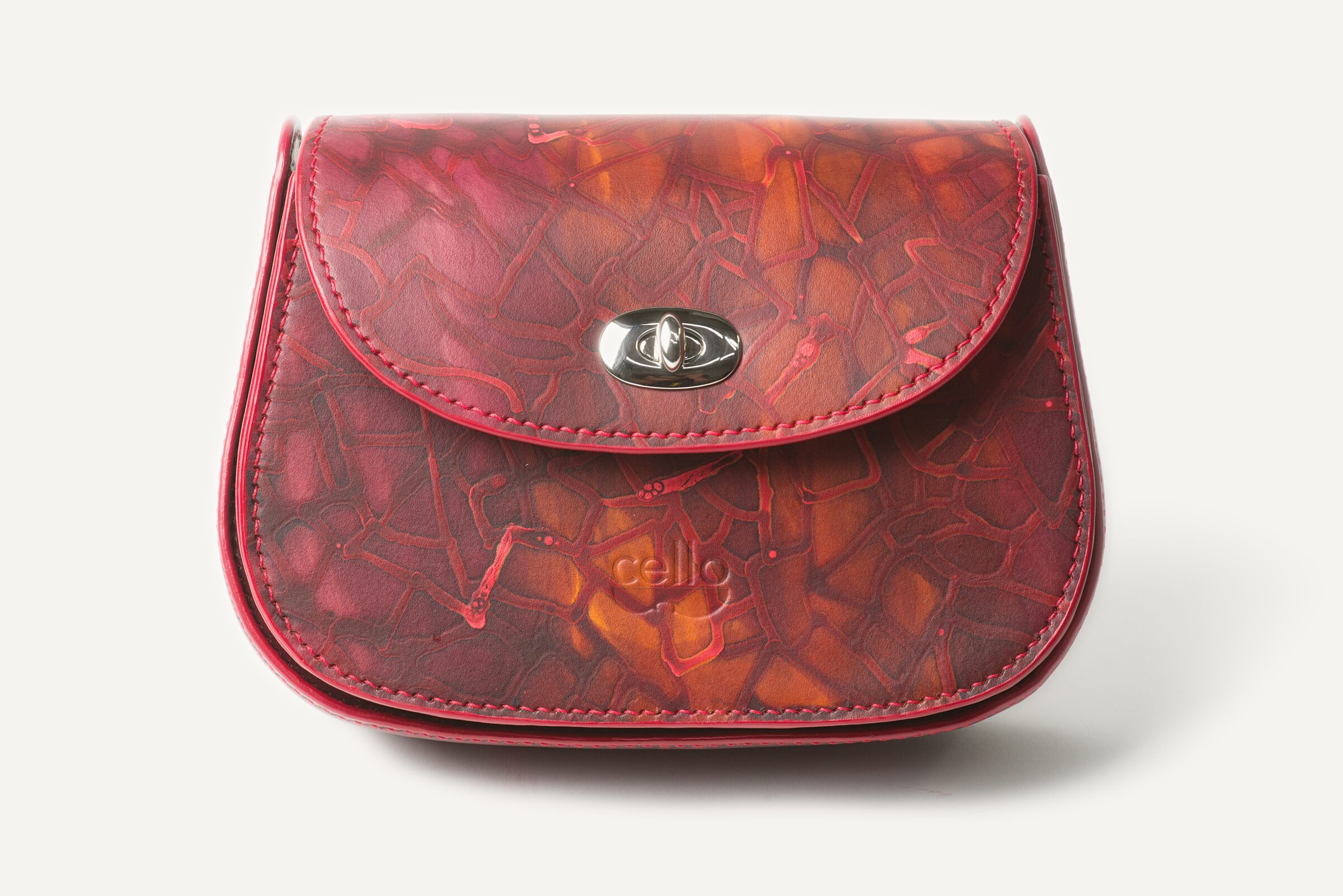 A small flap bag colored like glowing embers, deep reds broken by threads of orange