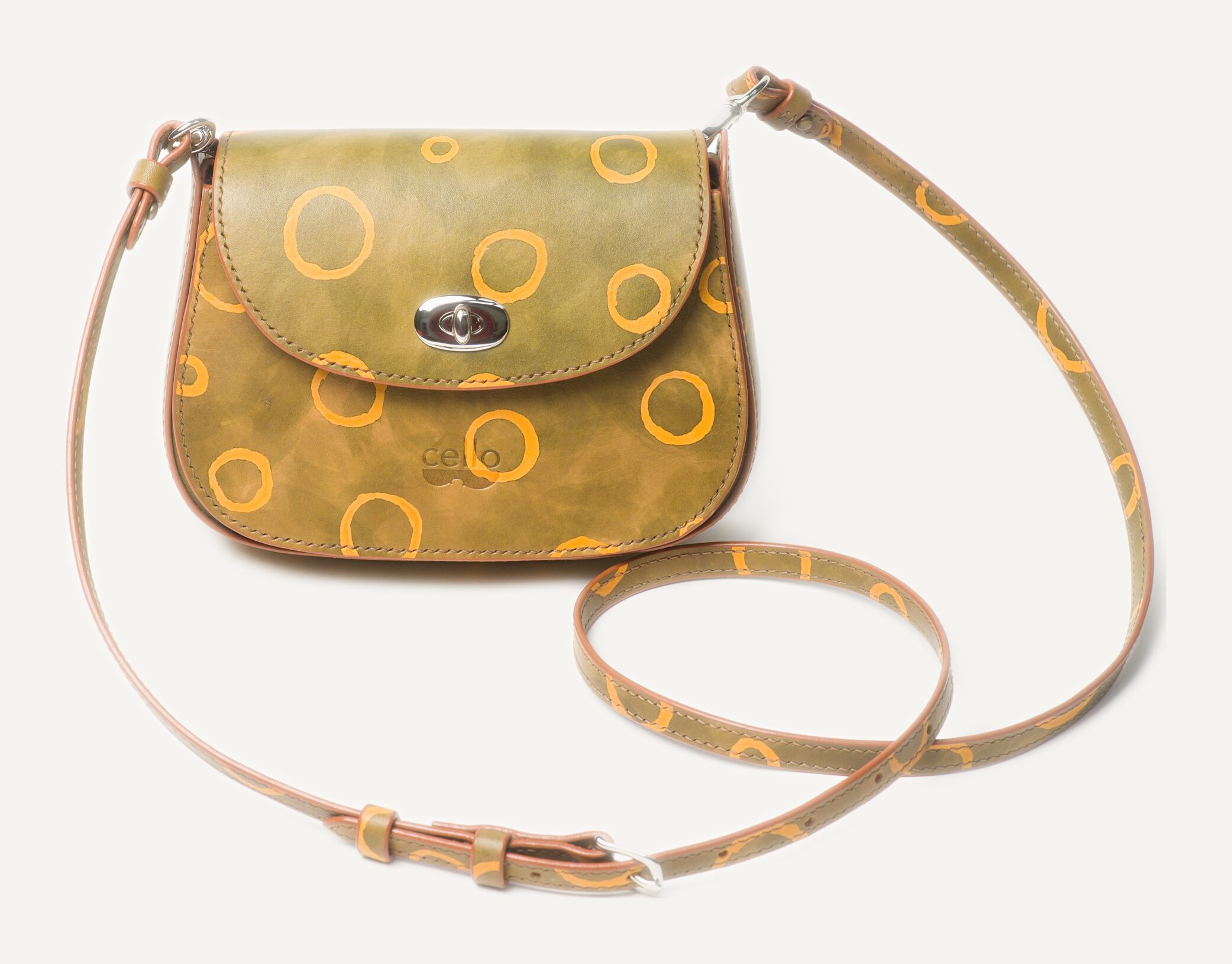 A sage-green bag with golden rings and a long matching strap